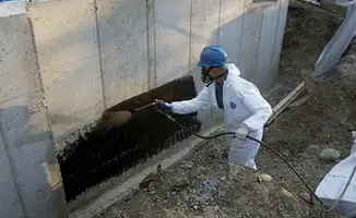 Professional waterproofing the exterior walls of the basement in Minneapolis, MN