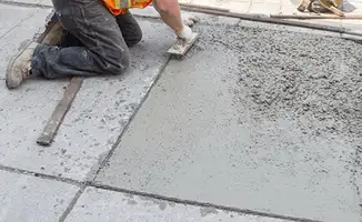 Professional repairing a concrete floor in Minneapolis, MN